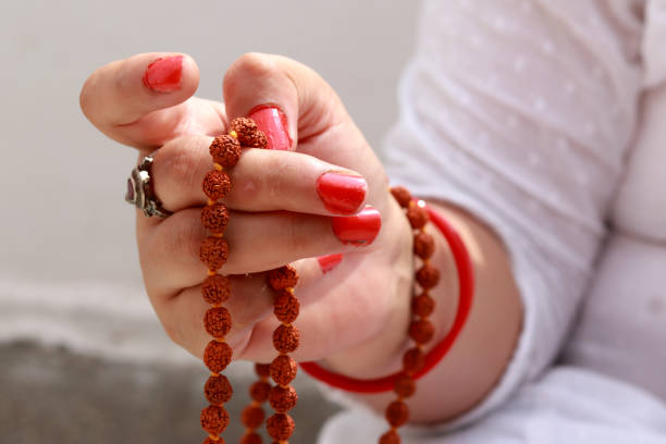 a woman holding rudraksha
